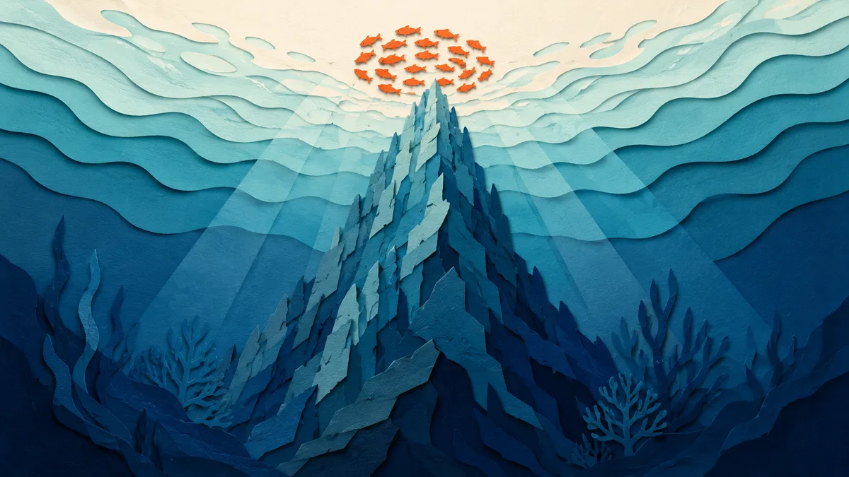 Illustrazione papercut di una secca rocciosa che si alza dal fondo profondo, con un branco di pesci sopra la sommita'